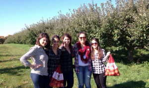 five friends in an orchard