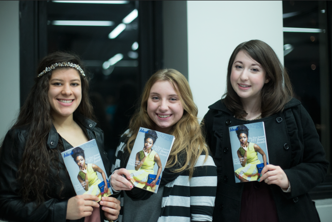 FIT students holding up the spring 2014 issue of Blush Magazine at the Launch Party