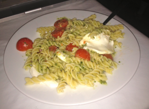 the classic pesto pasta with fresh cherry tomatoes and melted mozzarella