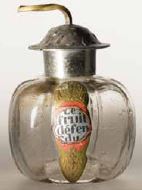 The bottle and packaging for Le fruit Defendu were designed by George Lepape, c. 1915.  The bottle takes the form of an apple, the symbol of sin, in the biblical tale of Adam and Eve.