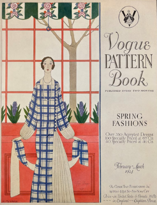 Woman in a blue and white floor length gown with puffy sleeves standing in front of a window with red panes