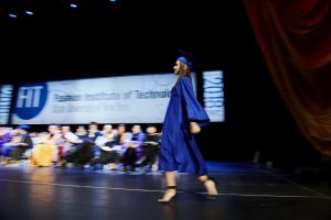 student walks across the stage