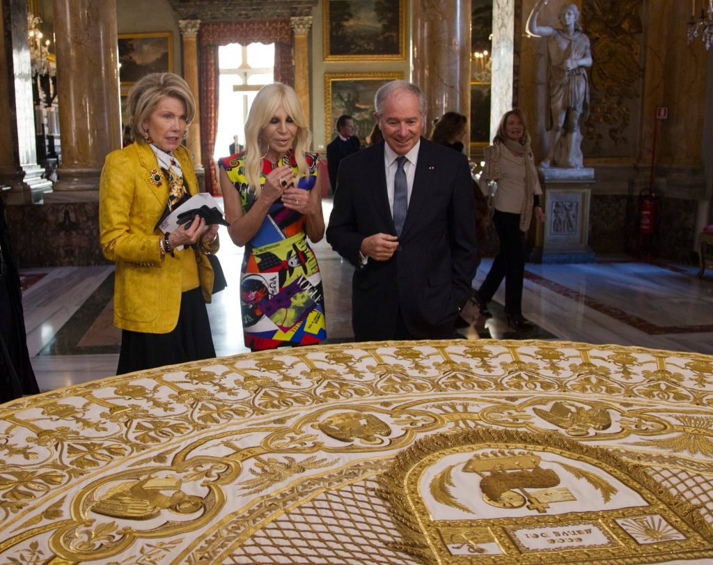 Chairpeople for the MMA Gala Mr. and Mrs. Schwarzman, Donatella Versace looking at an embroidered cope at the Vatican. Photo by Domenico Stillenis for AP.