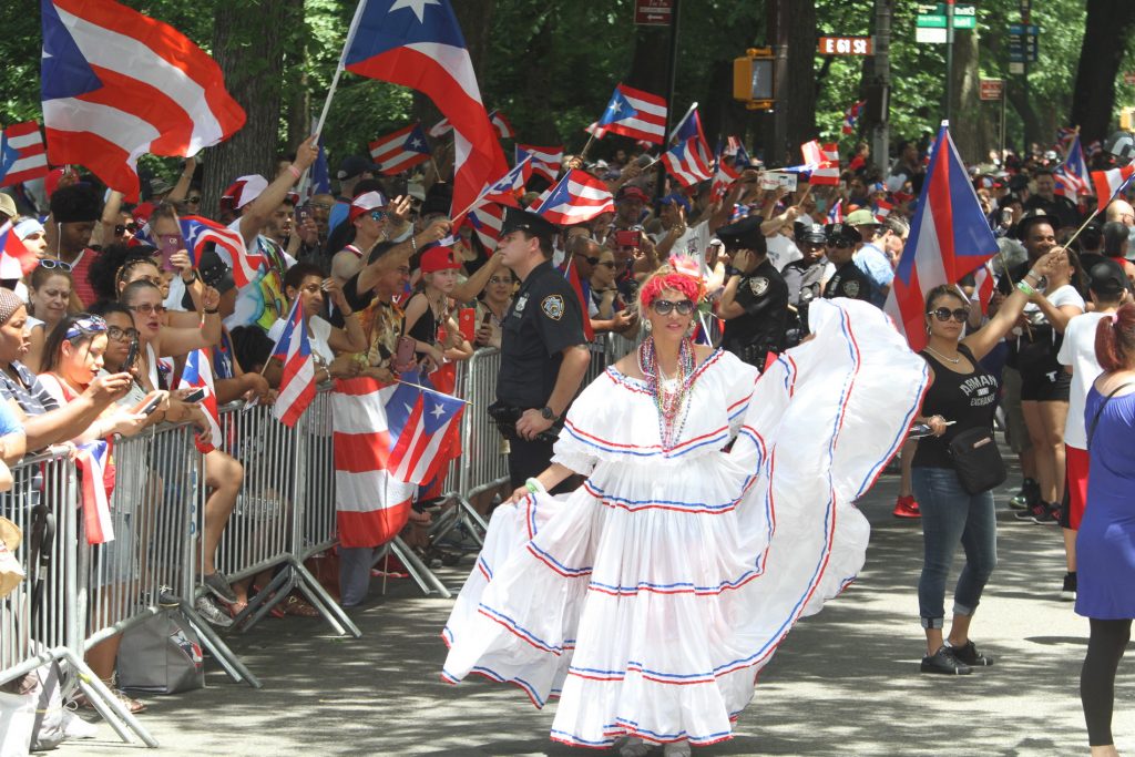 Woman in white dress in Puerto Rican Day Parade NYC 2018
