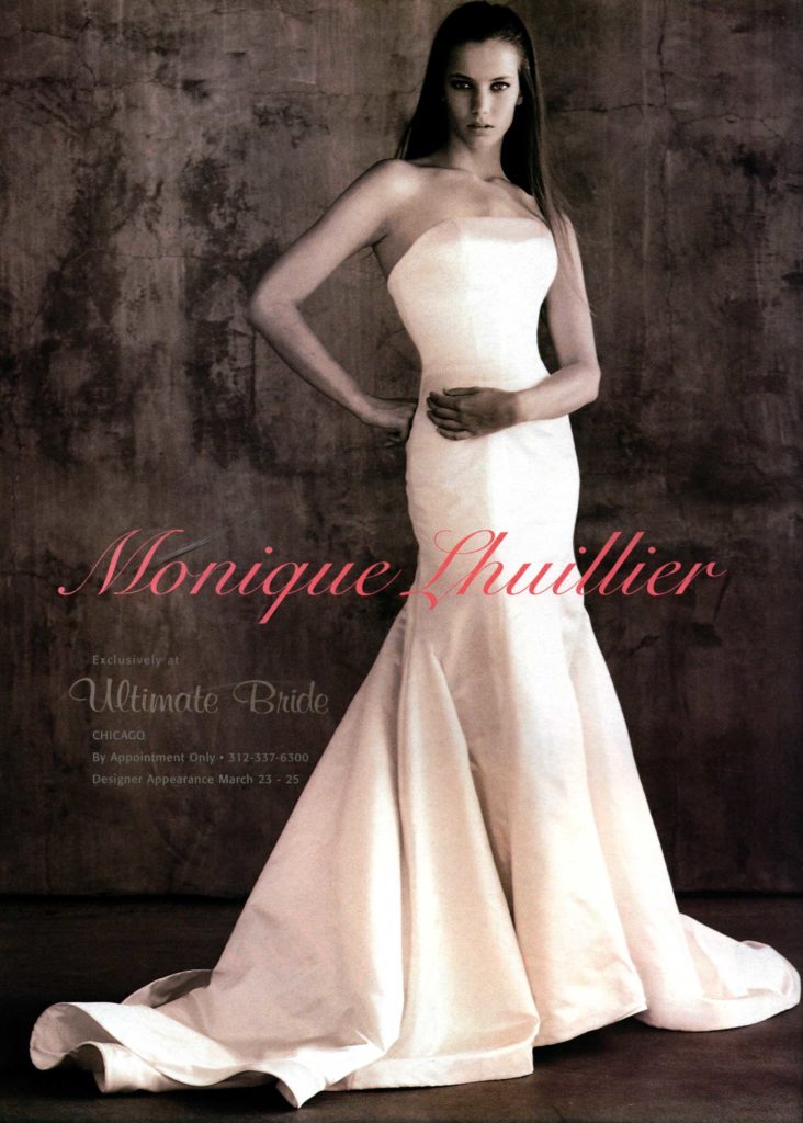 Full length image of woman in white strapless fitted gown with flare from knees to floor.
