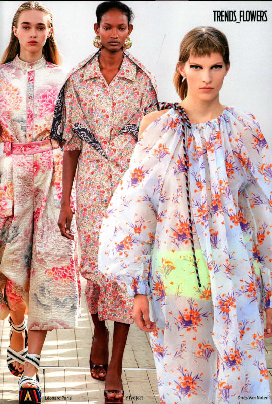 Three runway models wearing floral dresses