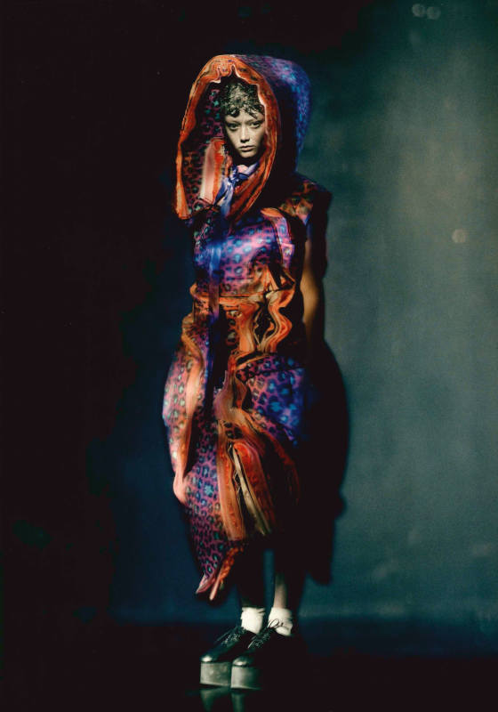 Model wearing dramatic pleated dress combinging multiple skin prints