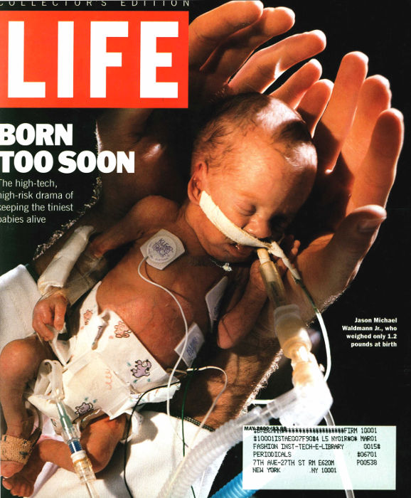 Life cover with premature baby in doctor's hands