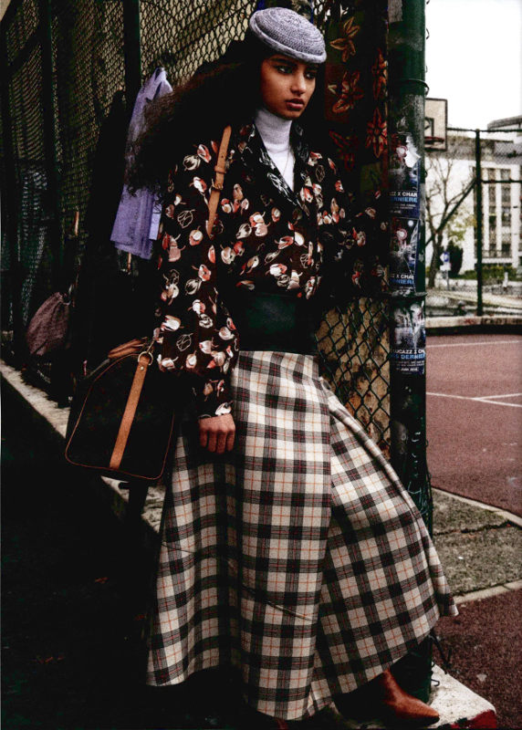 Woman standing in plaid skirt