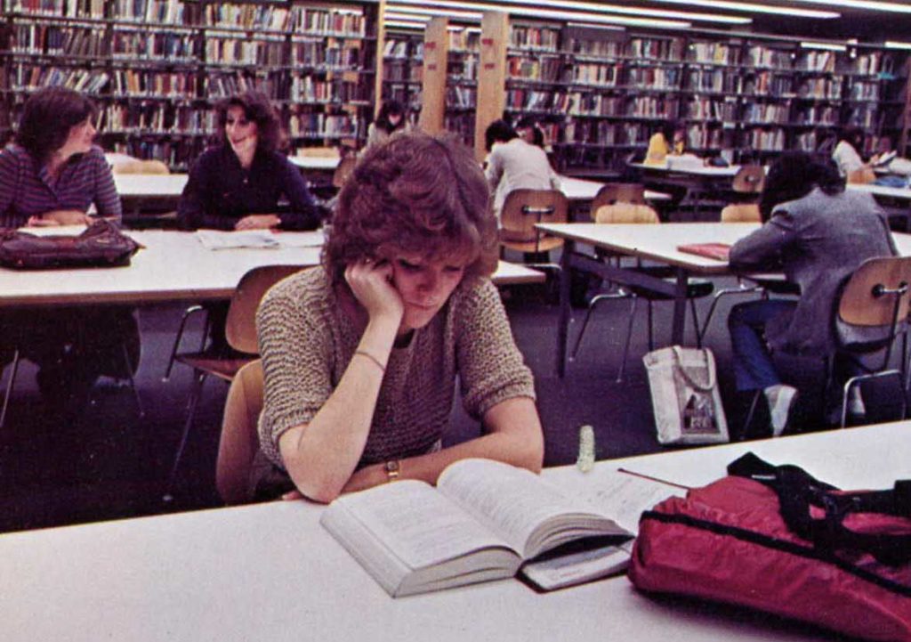 Students reading at a table in the library